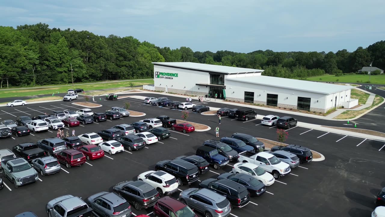 Aerial still of the full parking lot on opening day